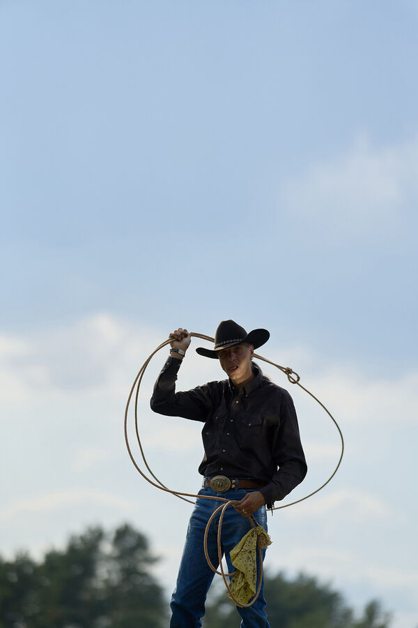 cowboy-in-black-hat-holds-a-la
